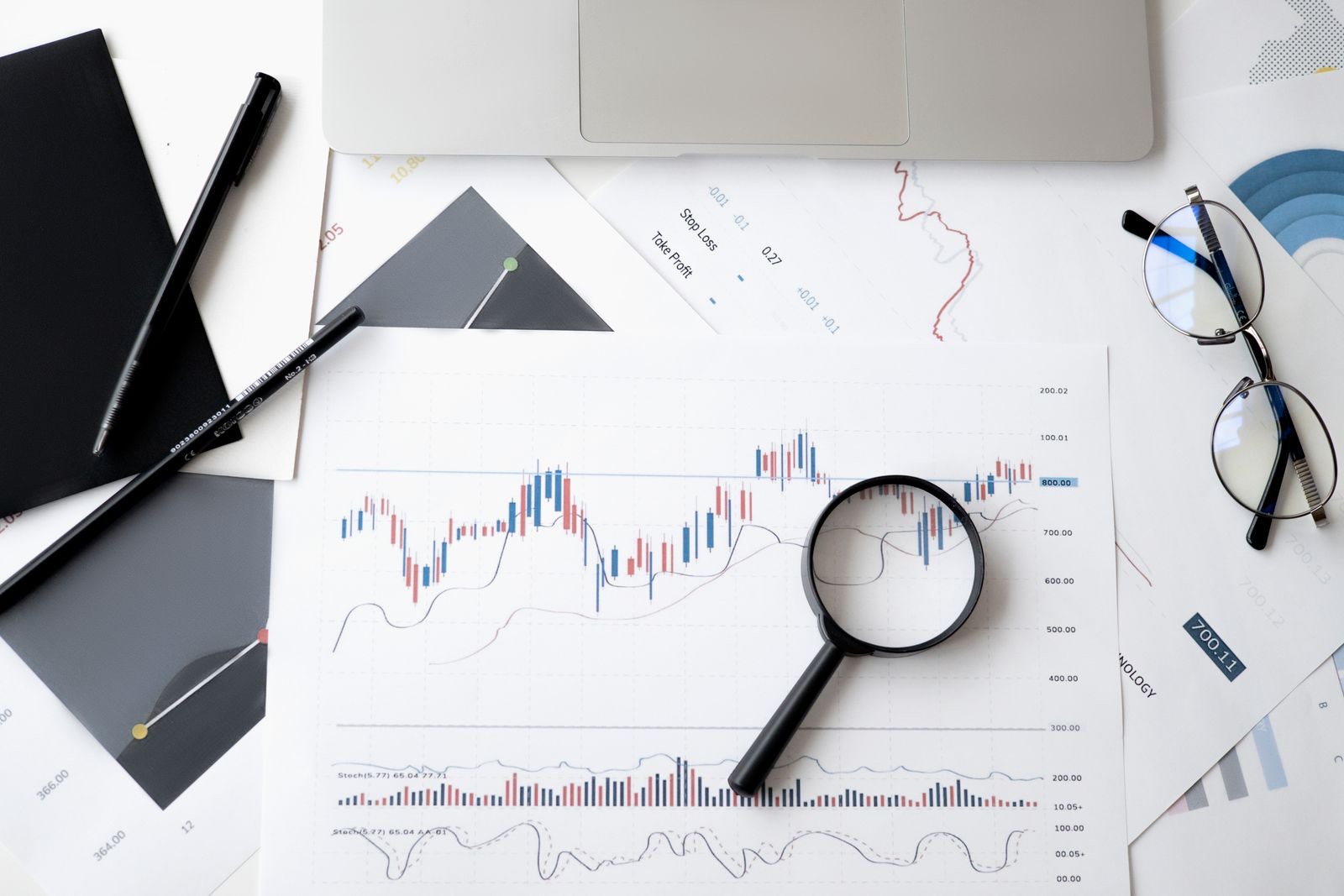 A magnifying glass over printed charts