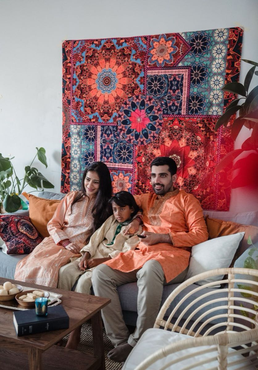 Family of three relaxing together at home